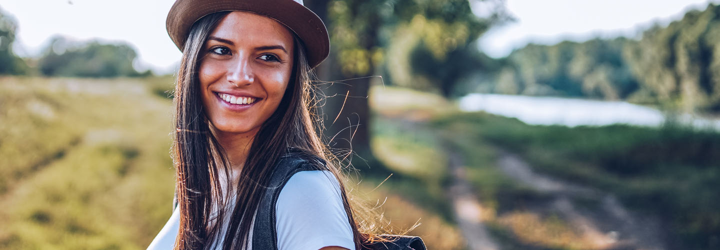 Woman smiling and hiking outside