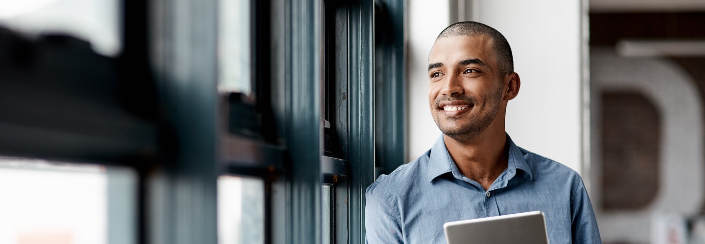 man smiling with tablet