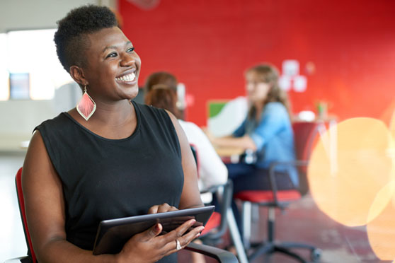 woman smiling with tablet