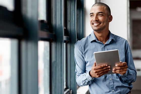man smiling with tablet